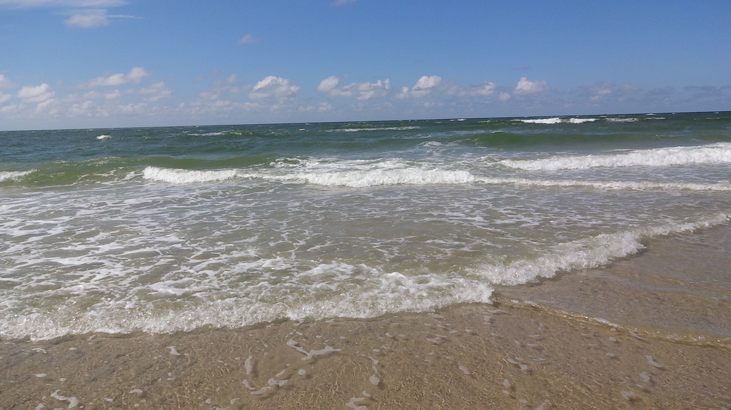 Strand mit Wellen und Himmel